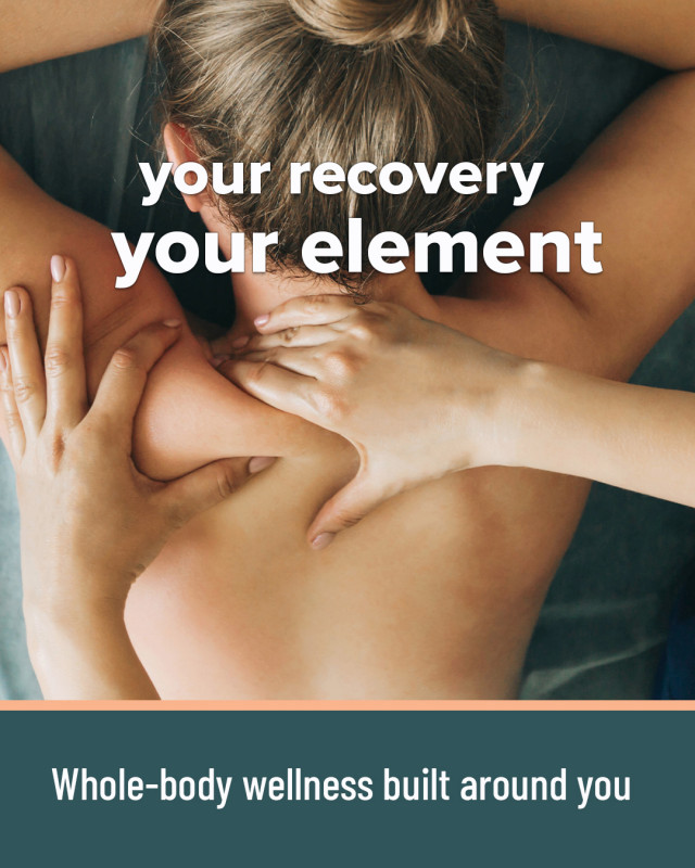 Therapist gently massaging a client's shoulders in a calm, softly lit treatment room