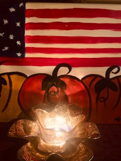 candle with flag and pumpkins