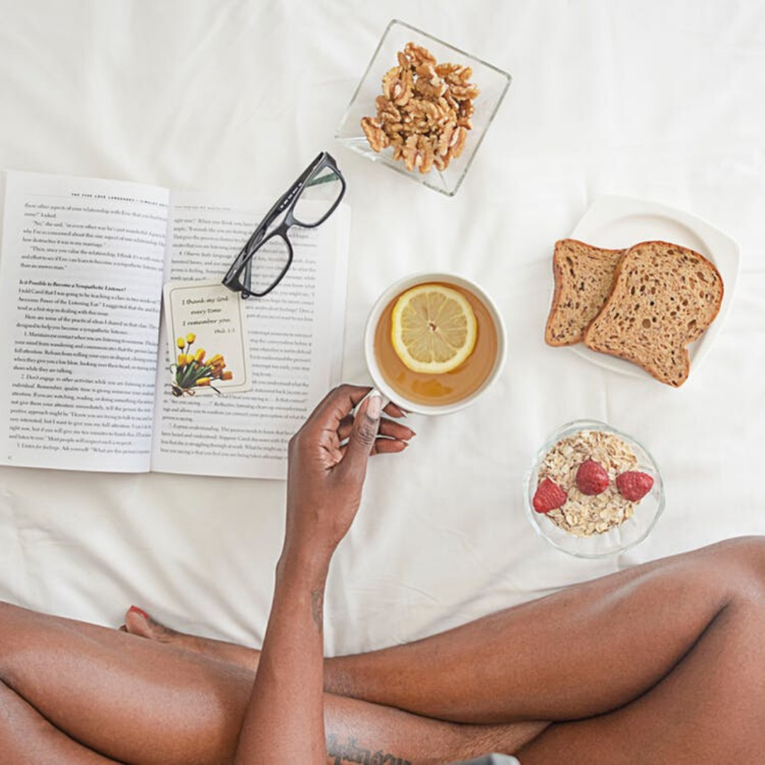 healthy breakfast in bed with a book