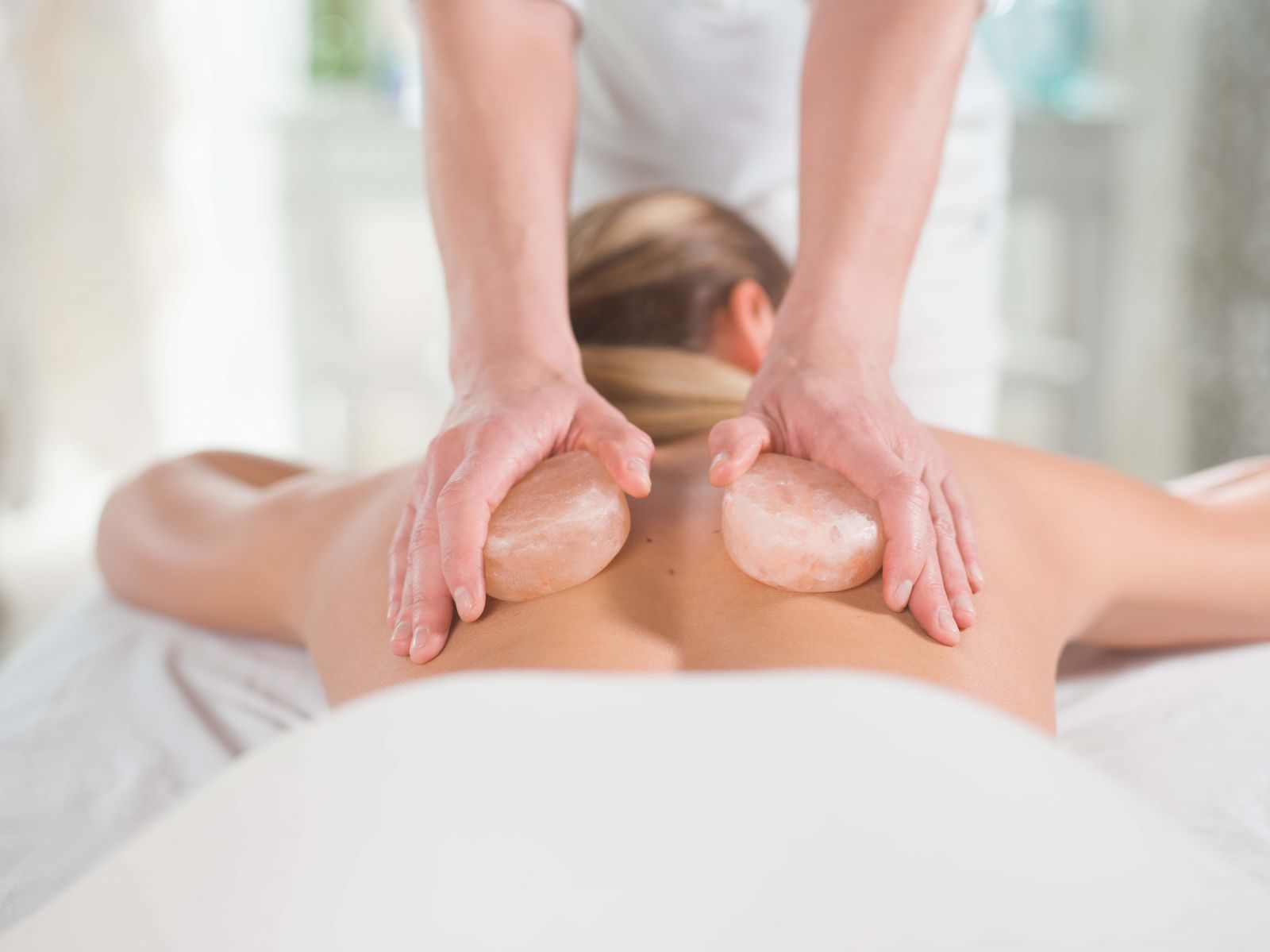 woman receiving himalayan salt stone massage