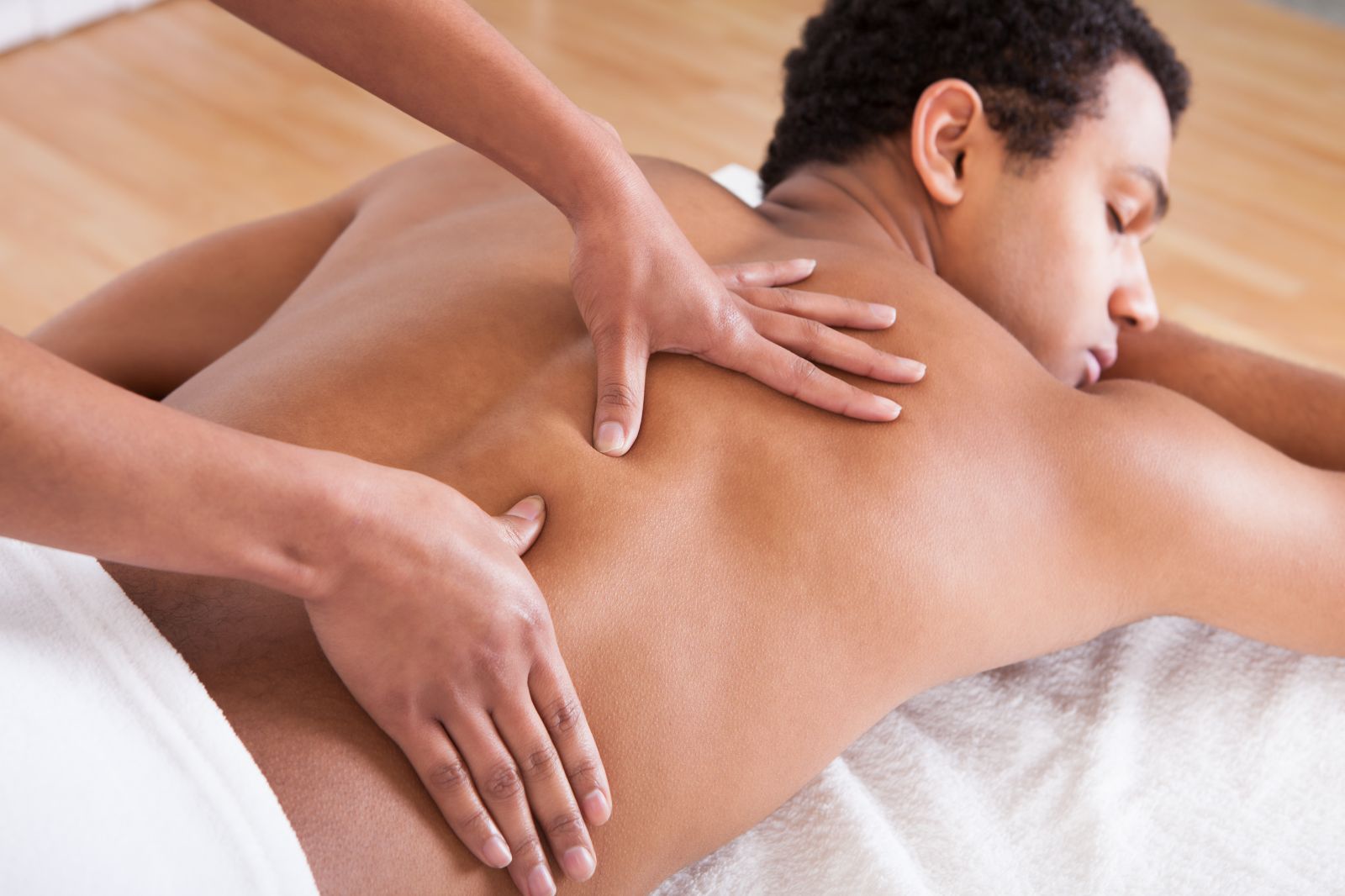 man receiving deep tissue massage at elements massage