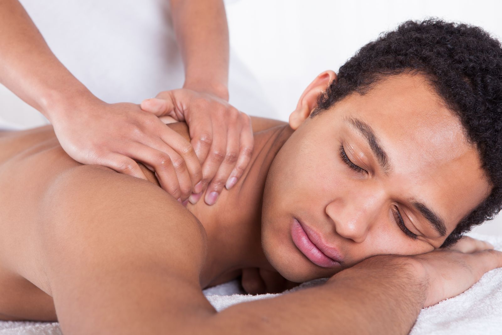 man getting sports massage therapy at elements massage